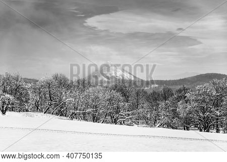 Winter Hilly Landscape Of Lusatian Mountains With Klic Mountain In The Middle. Czech Republic. Black