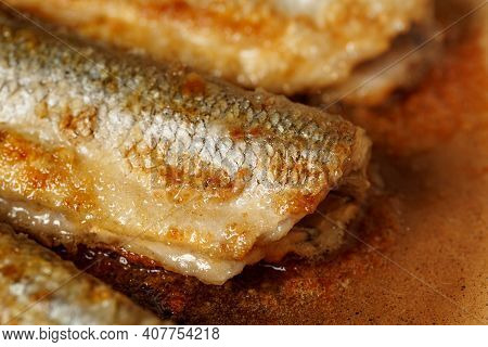 Fresh Smelt, Fried In Hot Oil In A Frying Pan For A Healthy Lunch Close Up. Smelt - Fish That Smells