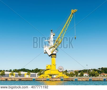 Yellow crane at Bayonne Port on the Adour River in France