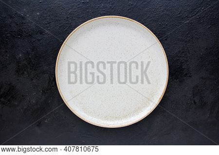 Empty White Ceramics Plate And On Dark Background.