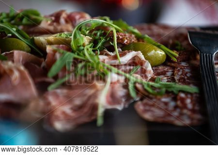 Close-up Of Basturma Sliced Into Pieces. Dried Meat With Cut Into Slices. Dried Horse Meat On A Wood