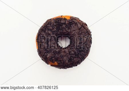 Chocolate Donut Decorated With Colorful Sprinkles Isolated On White Background. Flat Lay. Top View