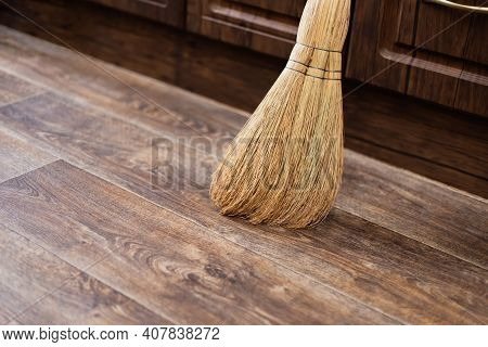 Cleanliness And Order At Home, A Broom Of Sorghum For Sweeping Is On The Floor Against The Wall In T
