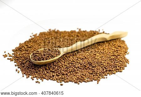 Buckwheat Tea In A Wooden Spoon On A White Background. Isolate. Buckwheat Tea Close-up Macro Photogr