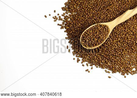 Buckwheat Tea In A Wooden Spoon On A White Background Copy Space. Isolate. Buckwheat Tea Close-up Ma