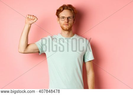 Confident Redhead Man Standing United With Black Lives Matter Movemet, Showing Raised Fist And Looki