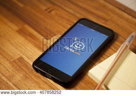 São Paulo, Brazil. Feb 12, 2021: Cell Phone With The Image Of The Cashier App Has On The Wooden Tabl
