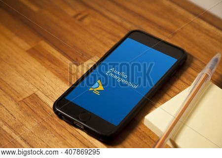 São Paulo, Brazil. Feb 12, 2021: Cell Phone With The Image Of Emergency Aid On The Wooden Table With