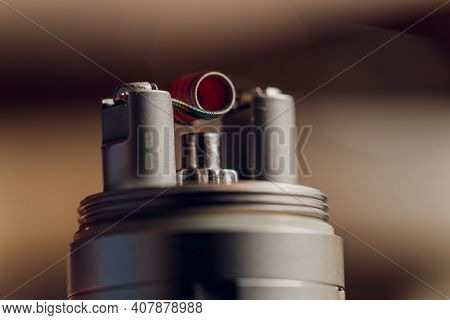 Vaping Device With A Hot Spring On A Black Background For Evaporation.