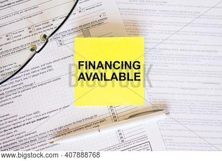 Yellow Sticker With Text Financing Available On Financial Docs. Notepad, Eyeglasses And White Pen