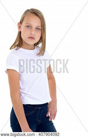 Blonde In A White T-shirt. Pretty Stylish Girl Posing In Studio On A White Background. Close-up Port