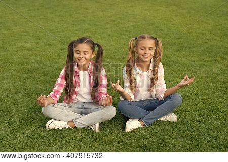 Practicing Mudras During Meditation. Happy Children Do Meditation On Green Grass. Small Girls Enjoy 