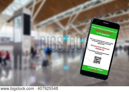 Mobile Phone App Showing Covid-19 Vaccination Certificate With Airport Background And Copy Space. Co