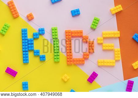 Kids Spelled Word With Plastic Blocks Background