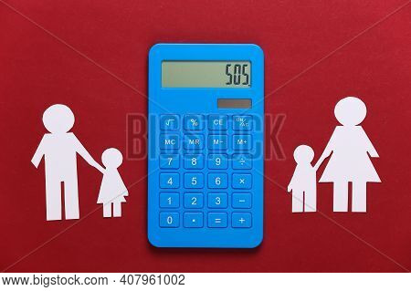 Broken Family, Divorce. Property Division Concept. Split Paper Family, Calculator On A Red Backgroun