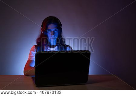 Student Or Programmer At A Laptop, Portrait In Neon Tinting. Funny Guy Geek Writes Code.