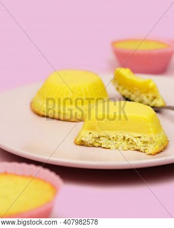 Traditional Gabonese Dessert Coconut Flan. Delicate Aromatic Flan With Coconut Flakes. Pink Backgrou