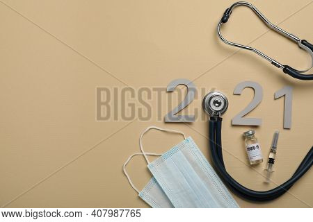 Paper Number With Stethoscope Forming 2021, Vial And Space For Text On Beige Background, Flat Lay. C
