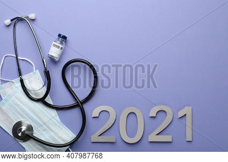 Flat Lay Composition With Coronavirus Vaccine On And Number 2021 Violet Background, Space For Text