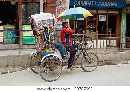 Traveller taking a local bicycle rickshaw,Kathmandu,Nepal