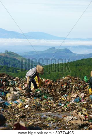 People pick up trash at garbage ground