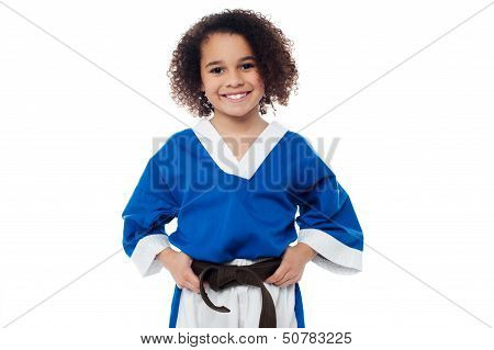 Little Girl Adjusting Her Brown Karate Belt
