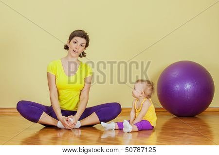 Mother Do Phisical Exercises With Her Daughter At Home
