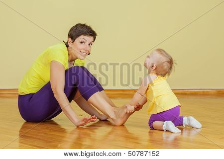 Mother Do Phisical Exercises With Her Daughter At Home