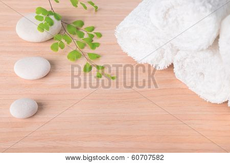 Spa Still Life With Stone, Green  Branch  And White Towel On Wood Background