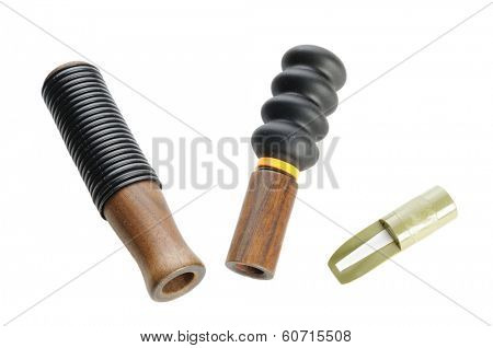selection of various types of game calls isolated on white