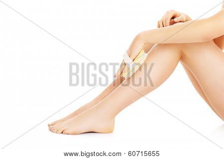 A picture of a woman doing peeling with a brush over white background