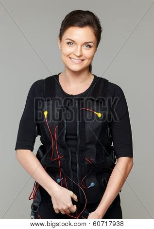 Young woman putting on  Electro Muscular Stimulation EMS exercise training costume 