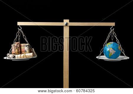 Earth and Money on a Two Pan Balance