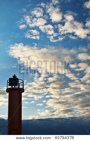Blue Cloudy Sky Background With Lighthouse Of Beacon On It.