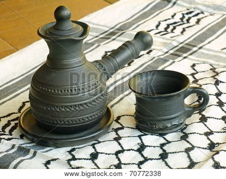 Ceramic Coffeepot And Cup On A White Keffiyah Scarf.