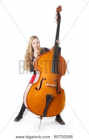Young Blond Girl Stands Behind Double Bass In Studio