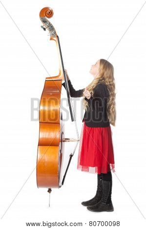Young Blond Girl Looks Up To Double Bass In Studio