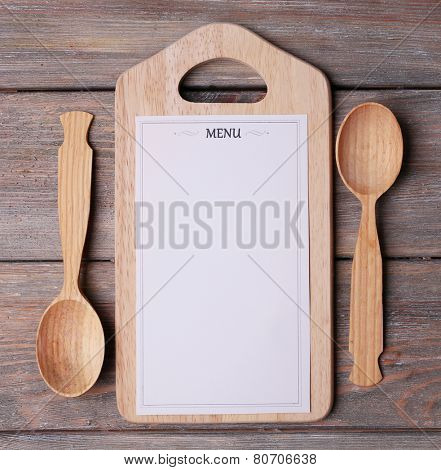 Menu sheet of paper on rustic wooden surface background