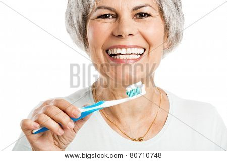 Portrait of a happy old woman brushing her teeth