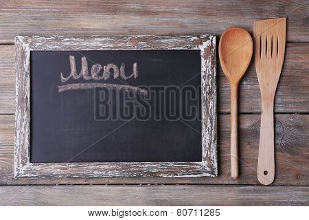 Blackboard menu on rustic wooden planks background