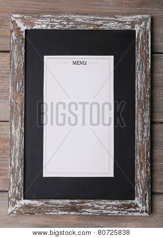 Blackboard with Menu sheet of paper on rustic wooden surface background