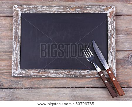 Blackboard blank on rustic wooden planks background