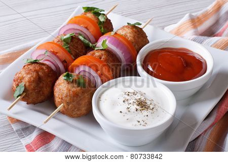 Delicious Meatballs On Skewers With Sauce On A Plate Horizontal
