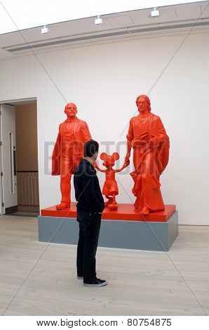 Visitor views the art work in a gallery