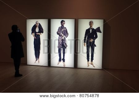 Visitor takes photo of the art work in a gallery