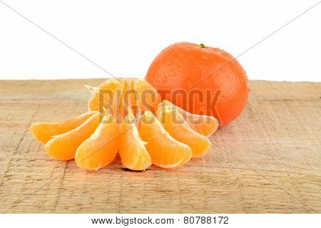 Mandarines With Pieces Isolated On Wooden Table