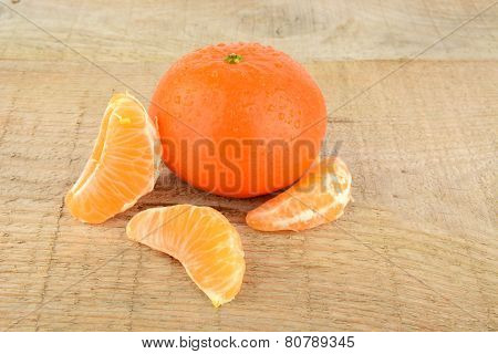 Mandarines With Pieces Isolated On Wooden Table