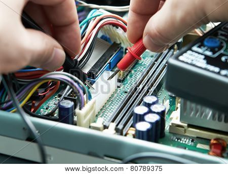 Close-up Of A Technician Hands With Multimeter.