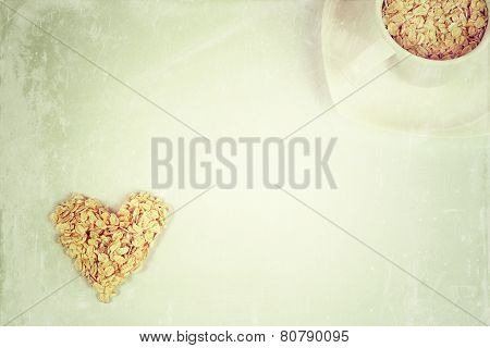 Oat flakes in a shape of heart and cup with saucer