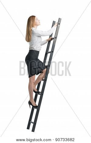 Beautiful Blonde Young Woman Is Climbing Up On The Ladder. Isolated On White Background.